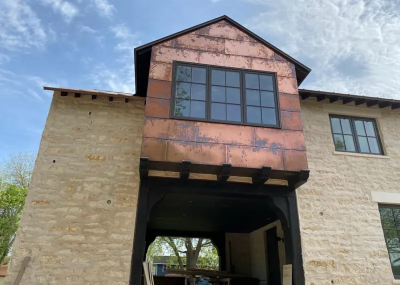 Copper metal panel facade on a stone building for Skylight Installation in Mount Horeb