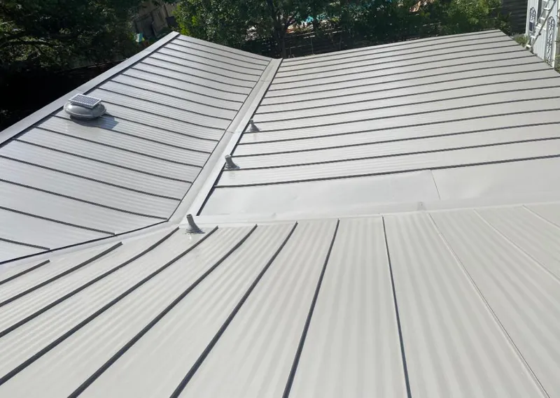 Solar attic fan installed on a metal roof for Roof Ventilation in Mount Horeb